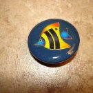 Large plastic button with colorful tropical fish. Large plastic button with colorful tropical fish.