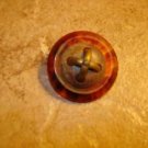 Vintage faux tortoisse button with embedded brass sign. Vintage faux tortoisse button with embedded brass sign.