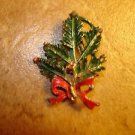 Metal Christmas holly with red bow brooch pin.