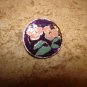 Signed silver metal button with pink flower.