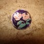 Signed silver metal button with pink flower.