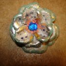 Large 3D flower shape painted metal button with blue rhienstone. Large 3D flower shape painted metal button with blue rhienstone.