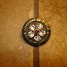 Vintage metal button with embeded rhinestone flower.