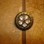 Vintage metal button with embeded rhinestone flower.