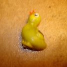Plastic yellow chicken button with brown wing.