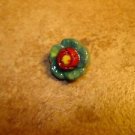 Small red and green metalized plastic button. Small red and green metalized plastic button.