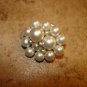 Vintage metal button with small and large pearls.