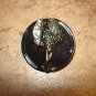 Large plastic button with metal wood fairy.