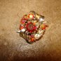 Silver metal button with aurora borealis like rhinestones.