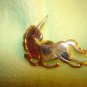 Gold metal unicorn horse pin badge.