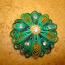 Large intrique plastic button with rhinestones and tiny pearls.
