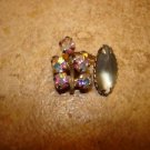 Vintage metal button with aurora borealis like rhinestones.