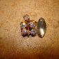 Vintage metal button with aurora borealis like rhinestones.