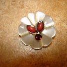 Carved plastic button with tier shape corals and garnet color stone.