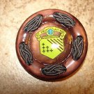 Extra large brown plastic button with Aut Vince Aut Mori sign. Extra large brown plastic button with Aut Vince Aut Mori sign.