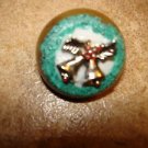 Christmas button with silver metal bells and holly.