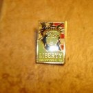 Gold tone metal brooch pin with Centenial Liberty Head 1886-1986. Gold tone metal brooch pin with Centenial Liberty Head 1886-1986.