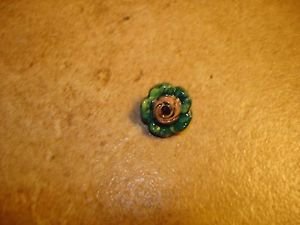 Painted yellow & green metalized plastic button.