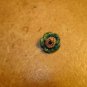 Painted yellow & green metalized plastic button.