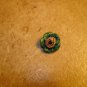 Painted yellow & green metalized plastic button.