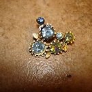 Old metal button with beautiful shiny blue rhinestones.