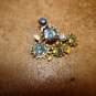 Old metal button with beautiful shiny blue rhinestones.