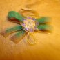 Bow shape metal button with tiny blue rhinestones.
