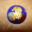 Blue plastic button with cat playing with butterfly. Blue plastic button with cat playing with butterfly.