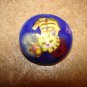Blue plastic button with cat playing with butterfly.