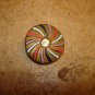 Metal button with pin wheel patern and rhinestone.