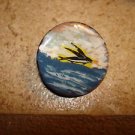 Old mother of pearl button with flying fish.