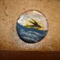 Old mother of pearl button with flying fish.