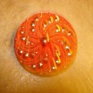 Large red glass pin wheel button. Large red glass pin wheel button.
