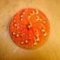 Large red glass pin wheel button.