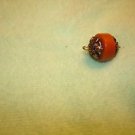 Brass and plastic small button.