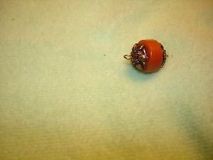 Brass and plastic small button.