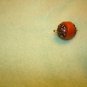 Brass and plastic small button.