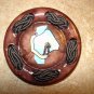 Large brown plastic button with braded rope.