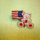 Teddy bear with American flag metal pin badge. Teddy bear with American flag metal pin badge.