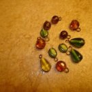 Lot of 12 small colorful glass buttons or beads. Lot of 12 small colorful glass buttons or beads.