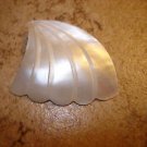 Large carved wing shape mother of pearl button.