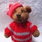 bear figurine with a little Red Knit Sweater and hat