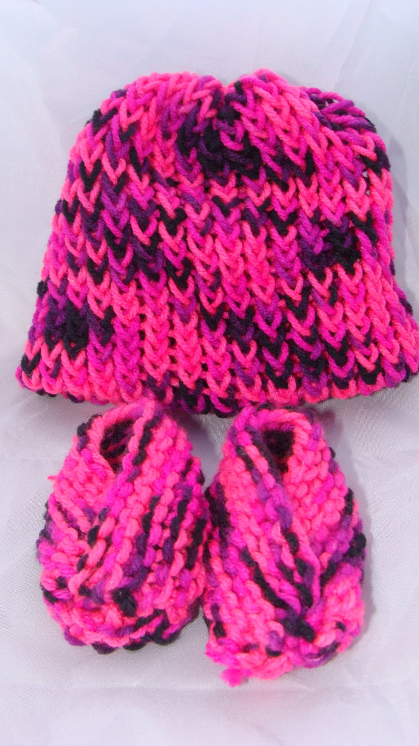 Pink baby booties and hat set