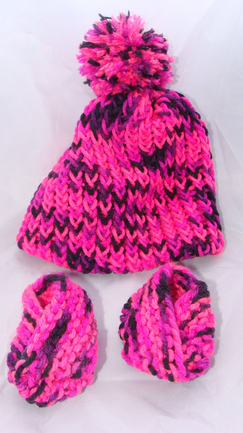 Pink baby booties with pompom hat set