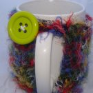 Fuzzy multi-colored mug koozie with button