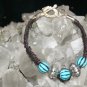 Black Handcrafted Hemp Bracelet with 3 Blue with 2 metal beads with a metal closure