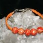 Orange Handcrafted Hemp with Orange Wooden Beads finished with a metal closure