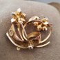 Lovely purple and lavender rhinestones grace this swirled and textured pin!