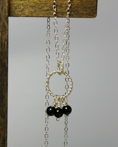 Sterling Silver Interlocking Twisted Rings with Hanging Black Onyx Pendant