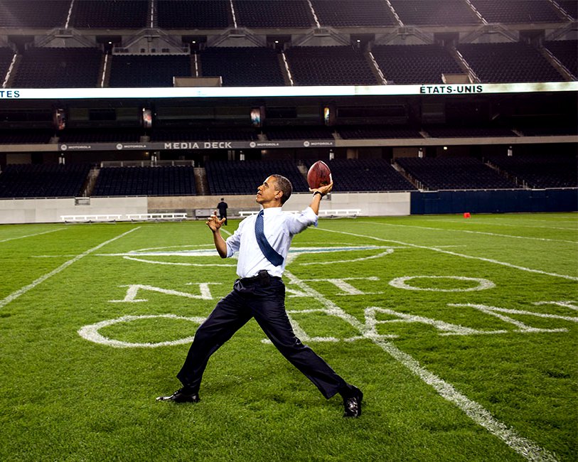 PRESIDENT BARACK OBAMA THROWS A FOOTBALL AT SOLDIER FIELD - 8X10 PHOTO (DD-069)